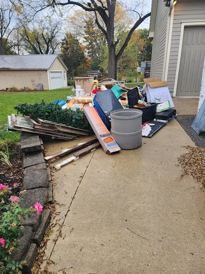 Dumpster being loaded with debris for 30 Yard Dumpster Rental in Woodbury